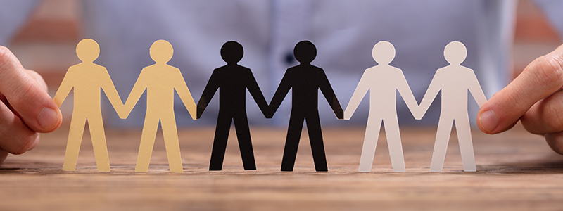 Businessperson Holding Human Figures